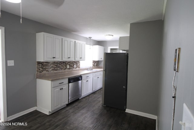 kitchen featuring white cabinetry, stainless steel dishwasher, dark hardwood / wood-style floors, and black fridge