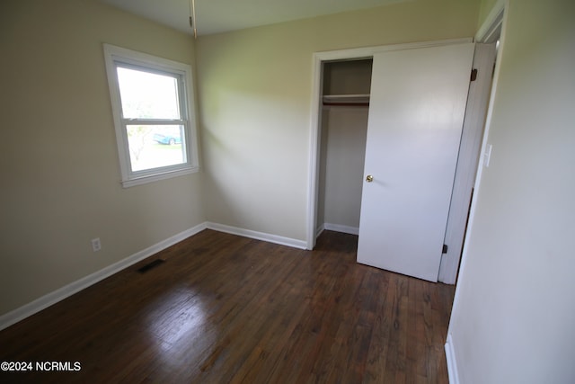 unfurnished bedroom featuring wood-type flooring and a closet