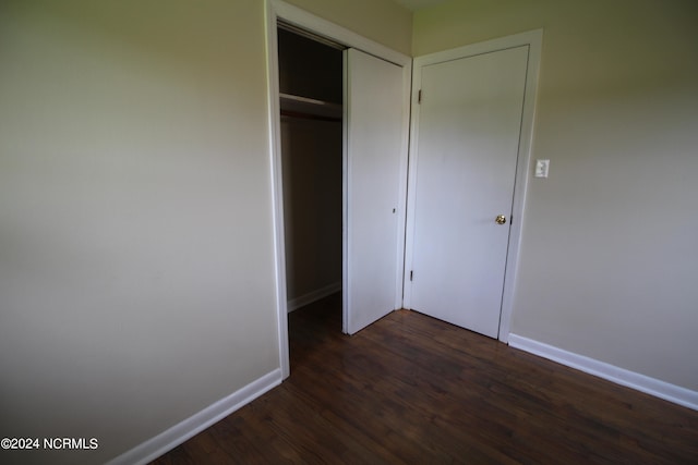 unfurnished bedroom with a closet and hardwood / wood-style floors