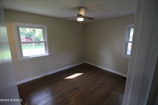 spare room featuring ceiling fan and dark hardwood / wood-style flooring