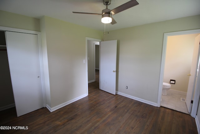 unfurnished bedroom featuring a closet, ceiling fan, connected bathroom, and dark hardwood / wood-style floors