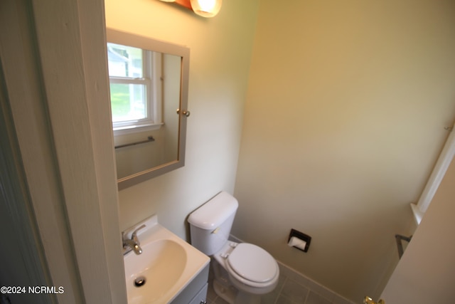 bathroom featuring tile patterned floors, toilet, and vanity