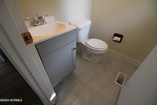 bathroom with tile patterned flooring, vanity, and toilet