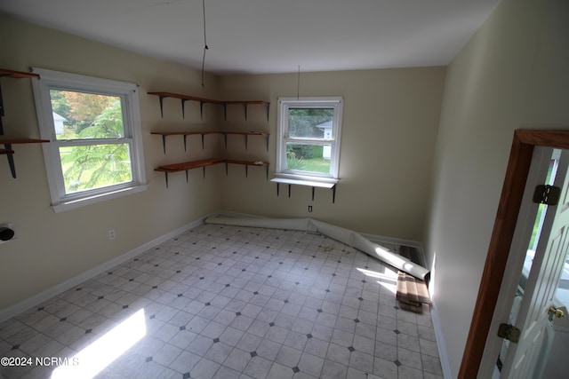 unfurnished room with light tile patterned floors