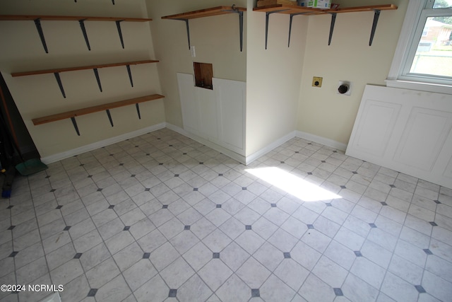 laundry area with light tile patterned floors and hookup for an electric dryer