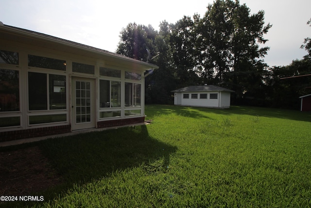 view of yard with a sunroom and an outdoor structure