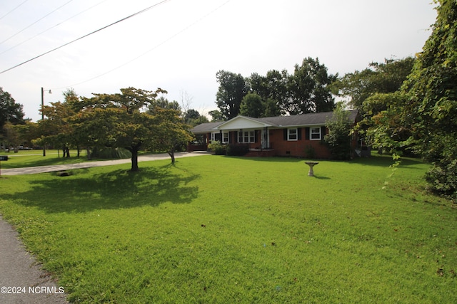 ranch-style house with a front lawn