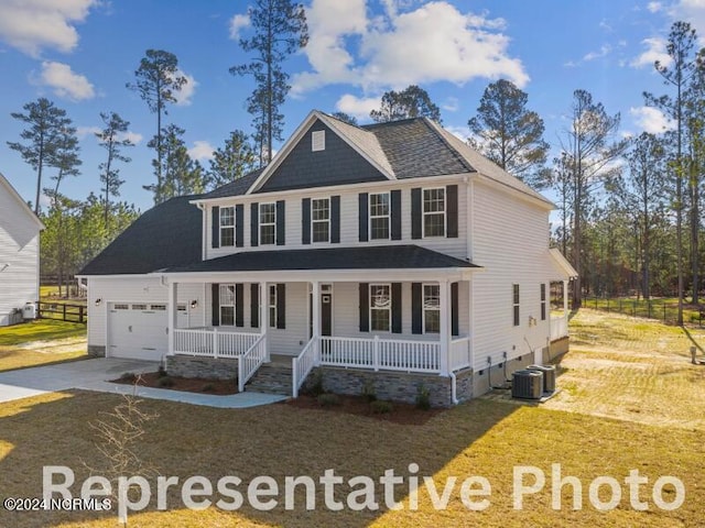 view of front of house with covered porch, central AC, a garage, and a front yard