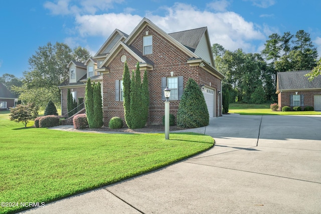 view of front of home with a front lawn and a garage