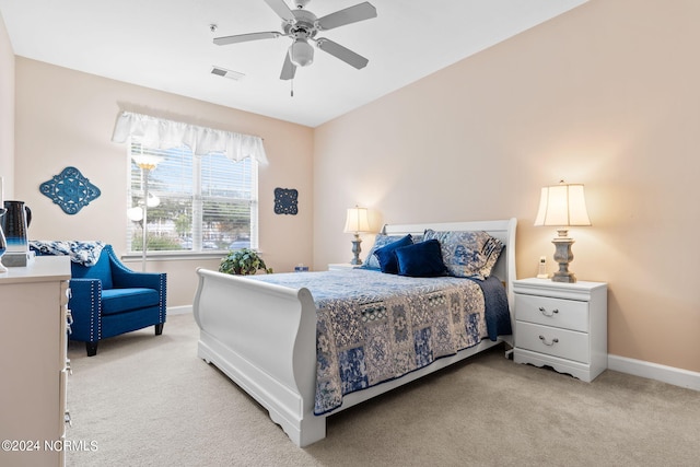 bedroom with baseboards, visible vents, and light colored carpet