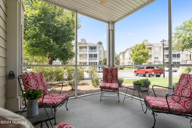 sunroom / solarium featuring ceiling fan