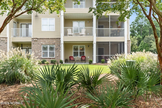 rear view of property with brick siding