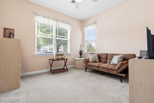 living area featuring ceiling fan, carpet floors, and baseboards