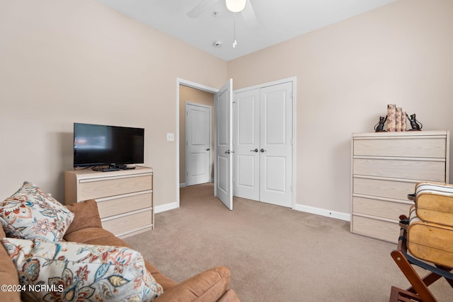 sitting room with carpet, baseboards, and a ceiling fan