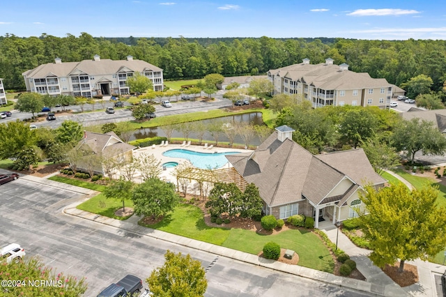 drone / aerial view with a water view and a view of trees