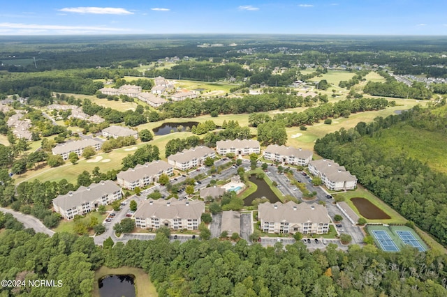 drone / aerial view featuring a residential view and a forest view