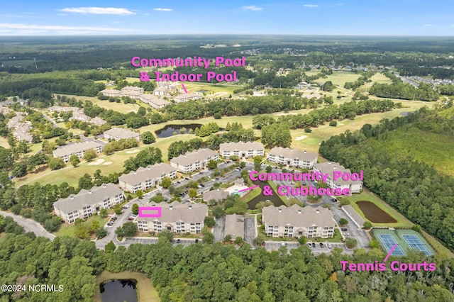 birds eye view of property featuring a forest view