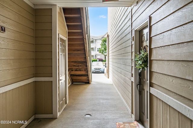 doorway featuring wooden walls