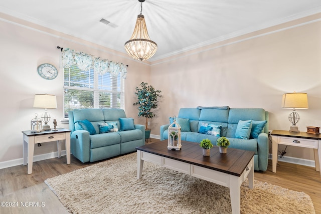 living room with light wood-type flooring, visible vents, ornamental molding, and baseboards