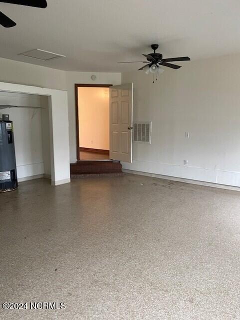 spare room featuring ceiling fan and electric water heater