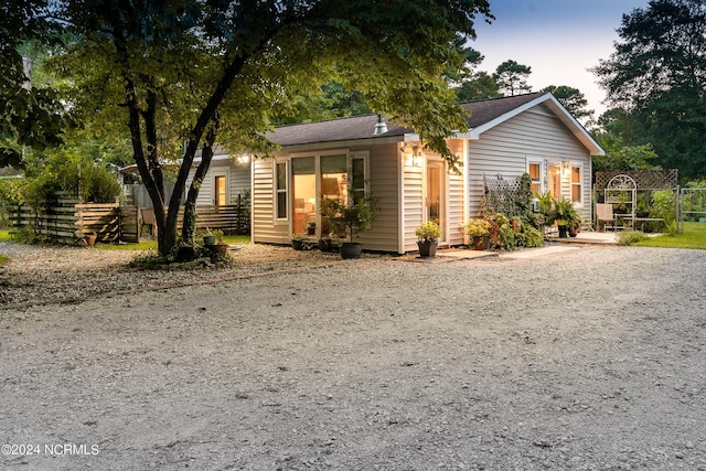 ranch-style home featuring fence