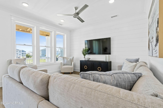 living room featuring a wealth of natural light, hardwood / wood-style flooring, and ceiling fan