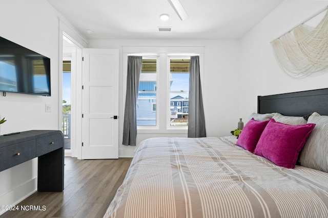 bedroom featuring access to outside and hardwood / wood-style floors