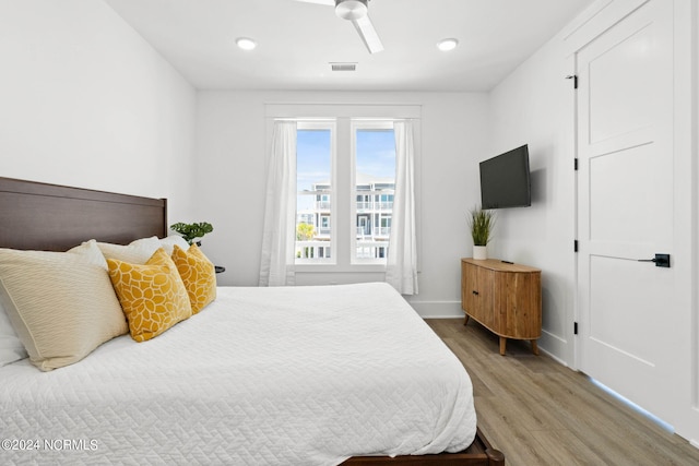 bedroom with ceiling fan and hardwood / wood-style flooring