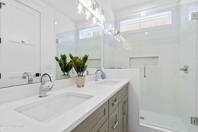 bathroom featuring vanity, a notable chandelier, and walk in shower