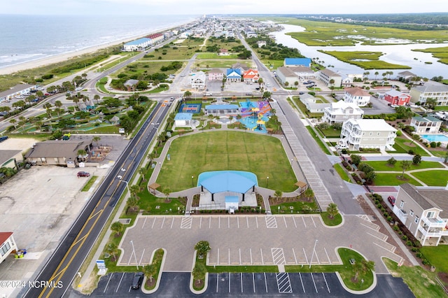 drone / aerial view featuring a water view and a beach view