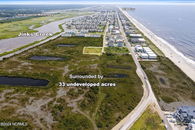 drone / aerial view with a water view and a view of the beach