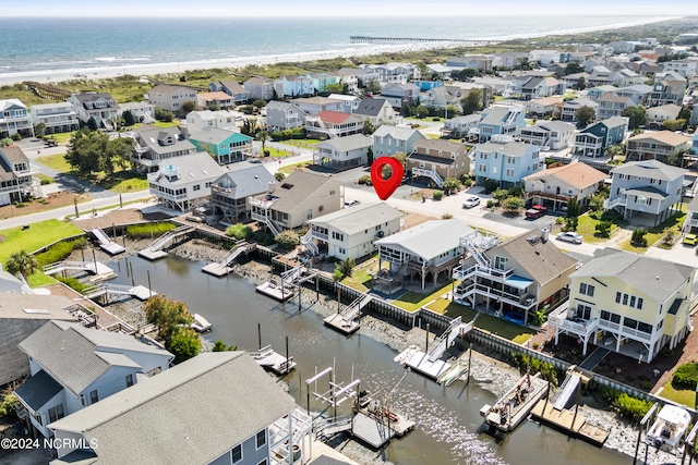 drone / aerial view featuring a water view and a beach view