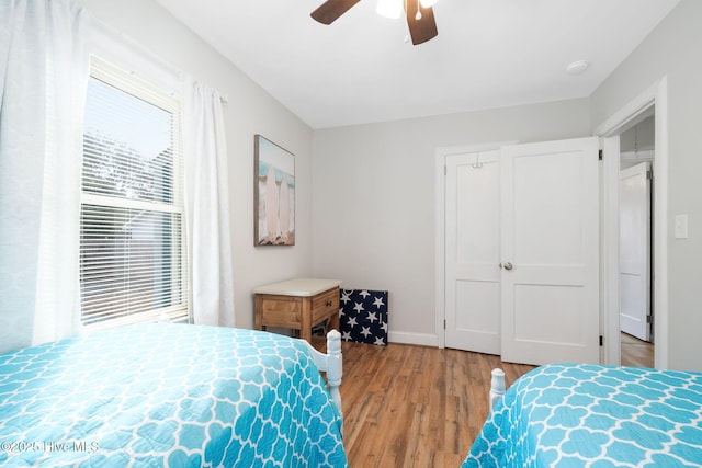 bedroom with ceiling fan and light hardwood / wood-style floors