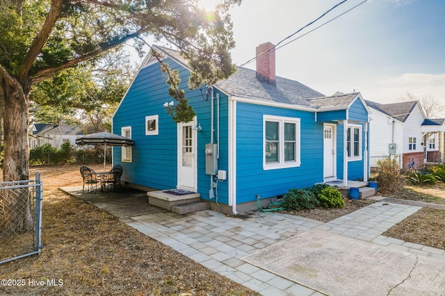 bungalow-style home with a patio area