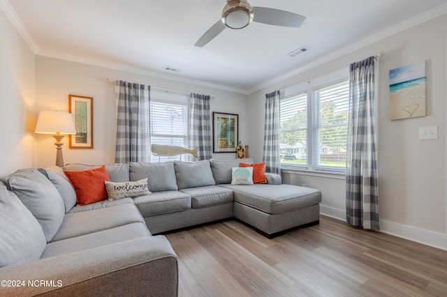 living room featuring light hardwood / wood-style floors, ornamental molding, and ceiling fan