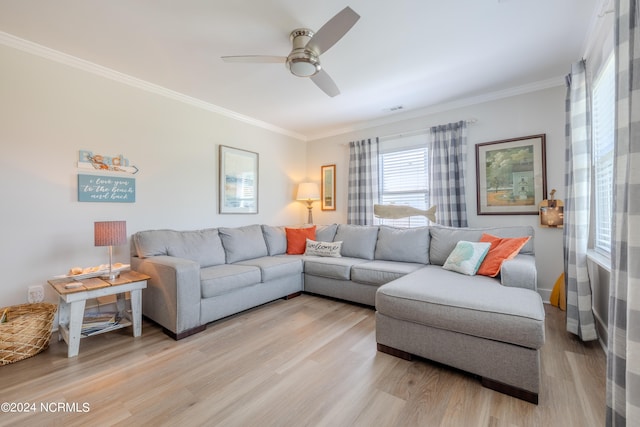 living room featuring light hardwood / wood-style floors, ornamental molding, and ceiling fan