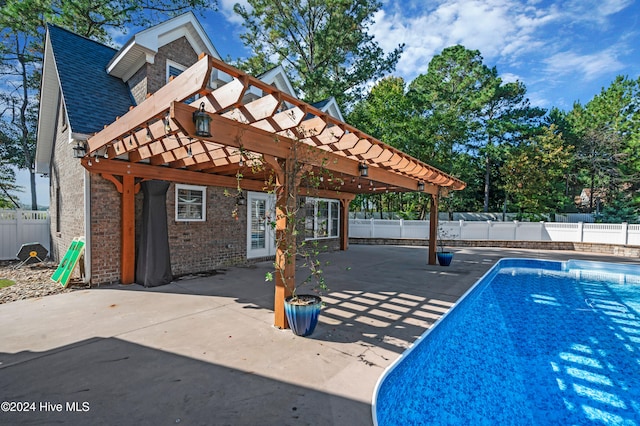 view of swimming pool with a patio and a pergola