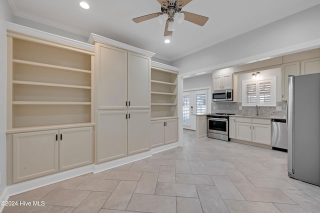 kitchen featuring ornamental molding, appliances with stainless steel finishes, decorative backsplash, sink, and ceiling fan