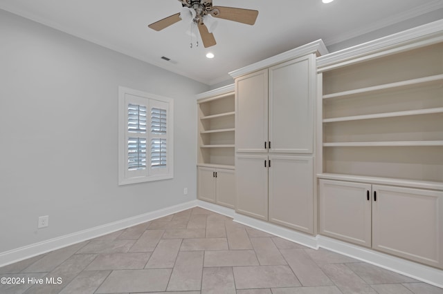 interior space with ceiling fan and crown molding