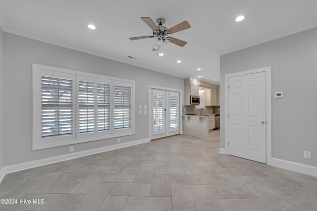 unfurnished living room with sink, ceiling fan, light tile patterned floors, and french doors