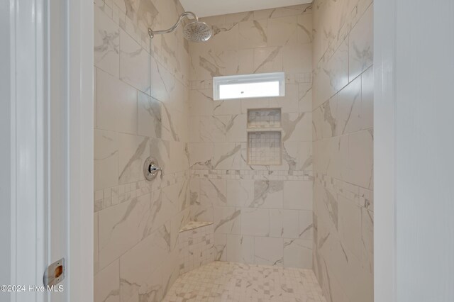 bathroom with a tile shower