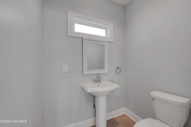 bathroom with toilet and tile patterned flooring