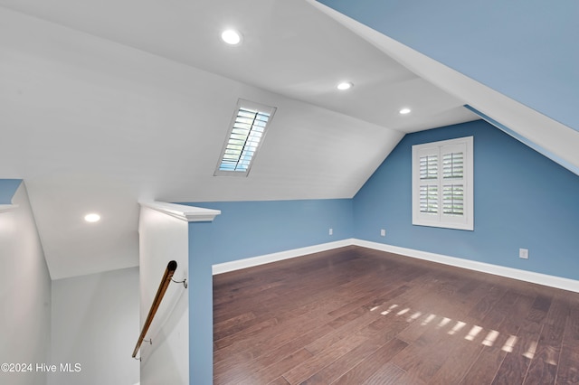 additional living space featuring wood-type flooring and lofted ceiling