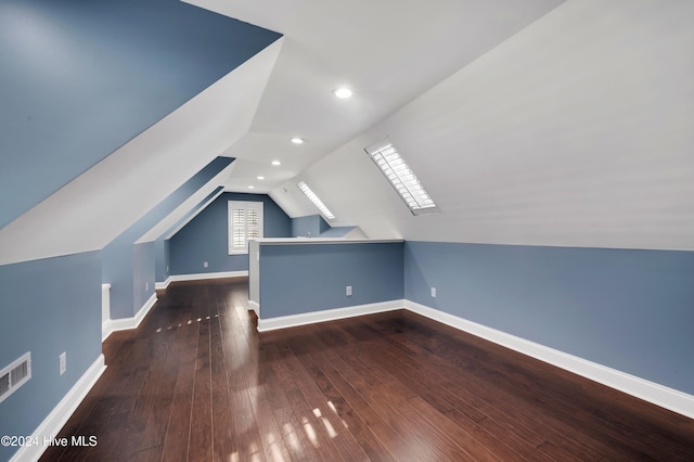 bonus room featuring dark wood-type flooring and vaulted ceiling