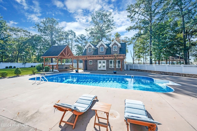 view of swimming pool with a patio and a gazebo