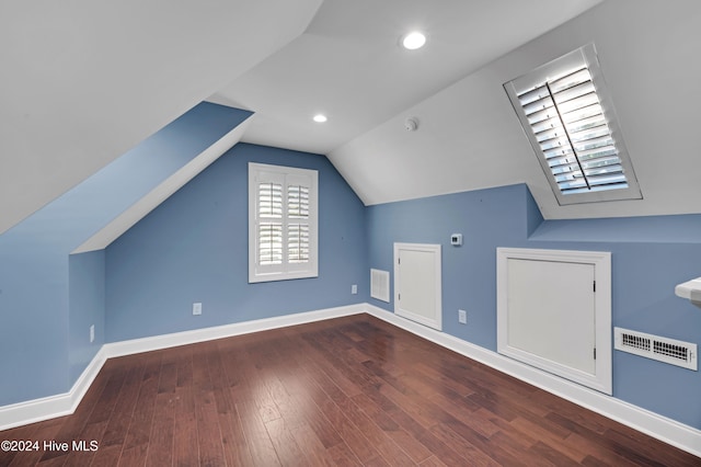 additional living space featuring hardwood / wood-style floors and vaulted ceiling