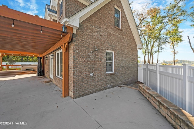 view of side of property featuring a patio area