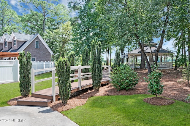 view of yard featuring a deck and a gazebo