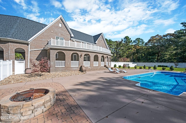 view of pool with a patio area and a fire pit