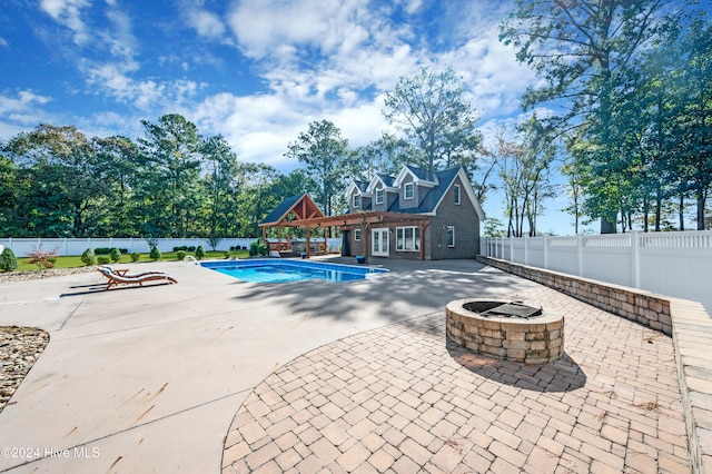 view of swimming pool featuring a fire pit and a patio area